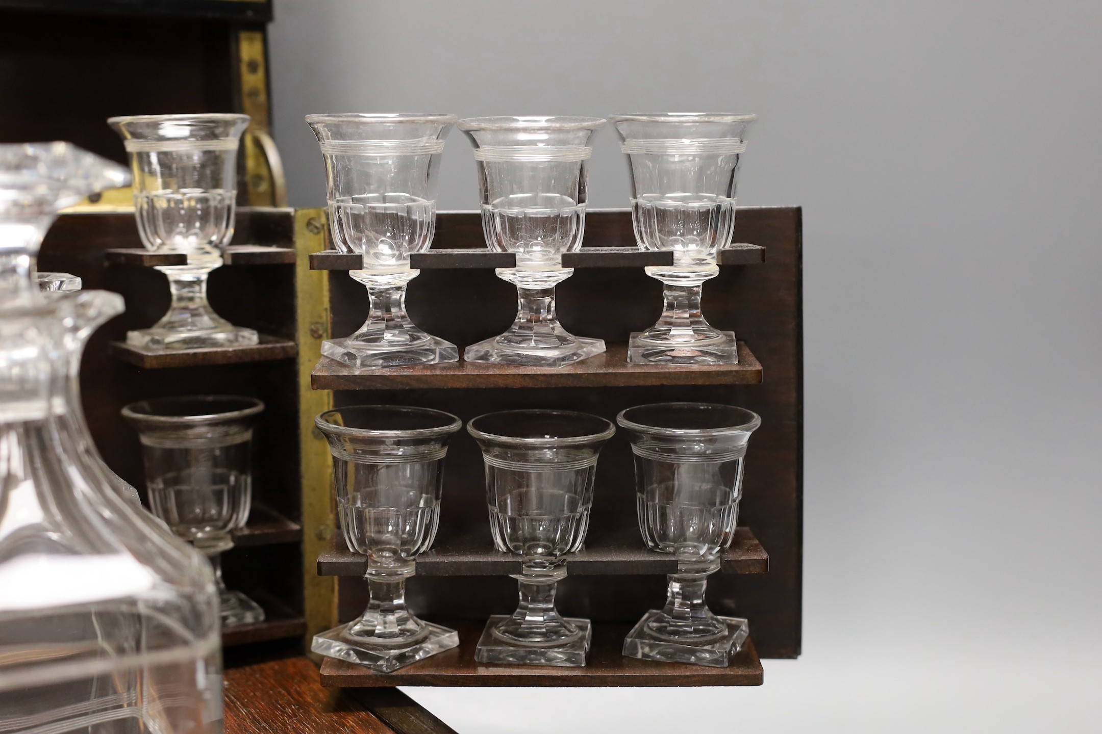 A 19th century mother of pearl and cut brass inlaid liqueur casket, 32cm, containing four original glass decanters and stoppers and 16 liqueur glasses